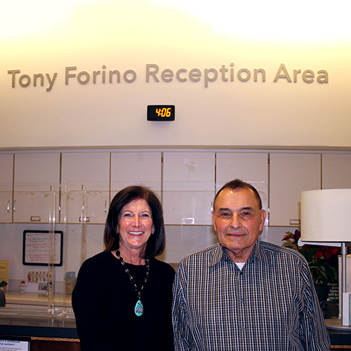 Mr. and Mrs. Forino standing in the new Tony Forino Reception Area