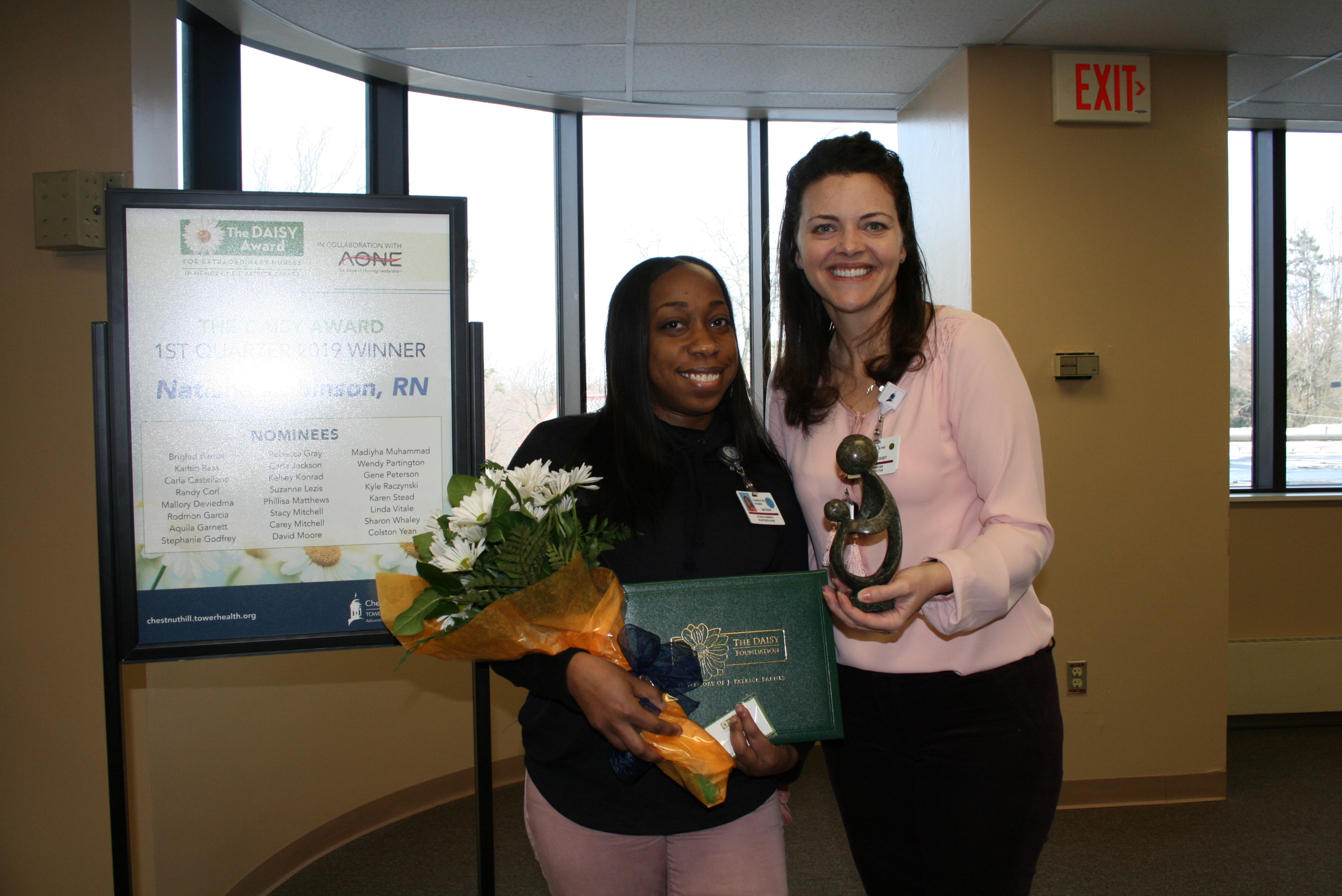 two women smiling after winning award