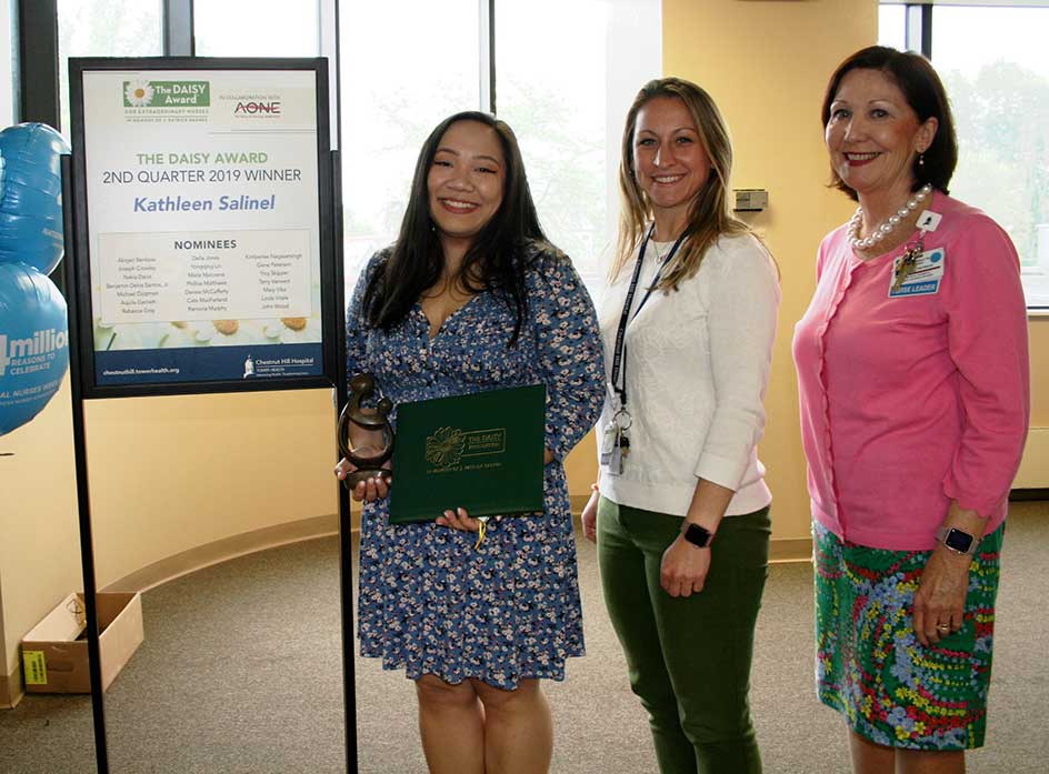 three females smile after winning award