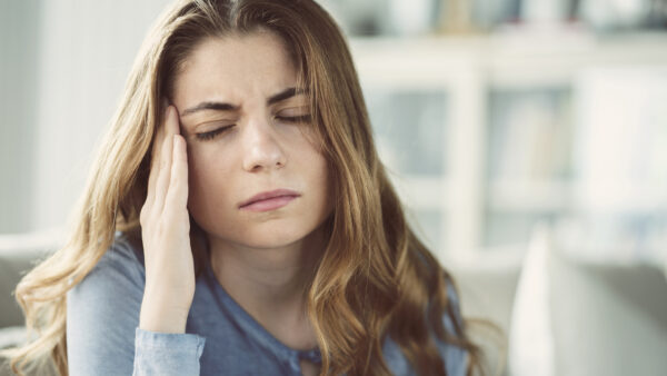 Woman rubbing head