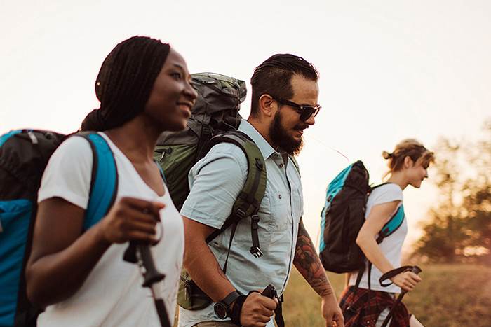 A group of hikers enjoy a sunset together.