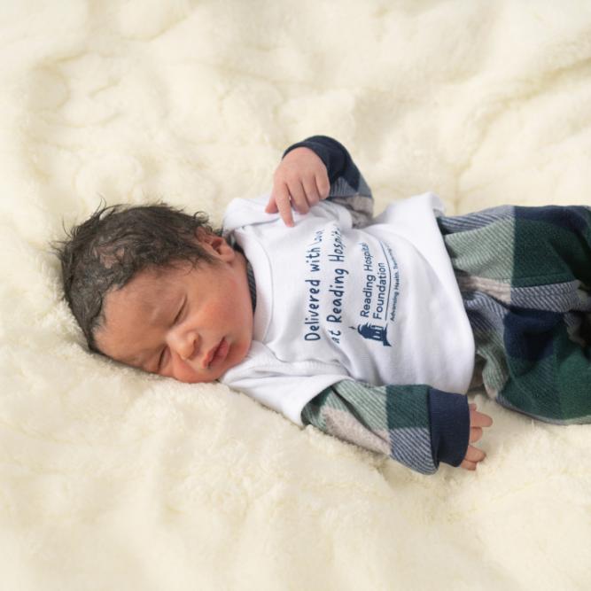 A newborn wears a t-shirt with "Delivered with Love at Reading Hospital" courtesy of the Reading Hospital Foundation., for all babies born at Reading Hospital-Beginnings Maternity Center
