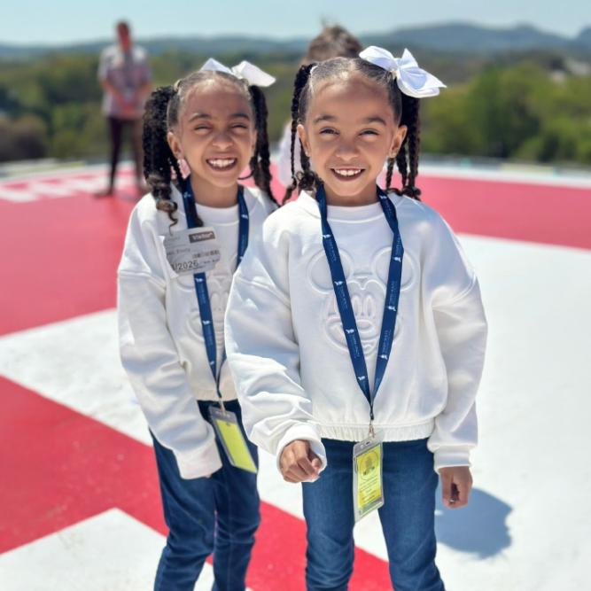 Two elementary school students on the helipad at Tower Health