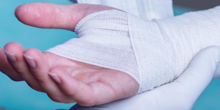 Hand being bandaged 