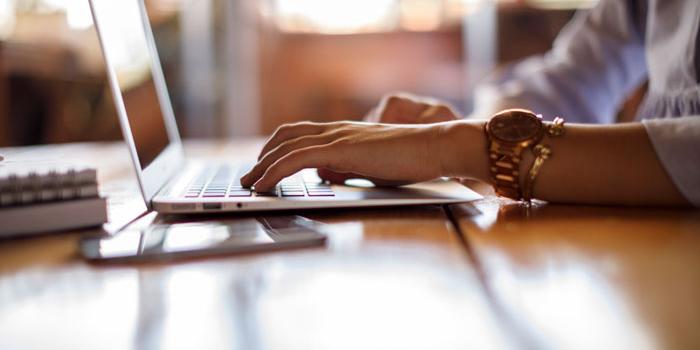 hands typing on keyboard