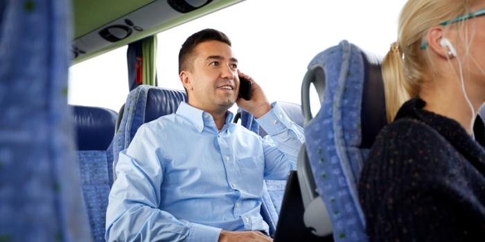 man on bus talking on phone