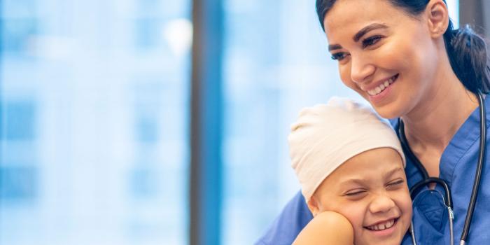 Doctor hugging girl patient.