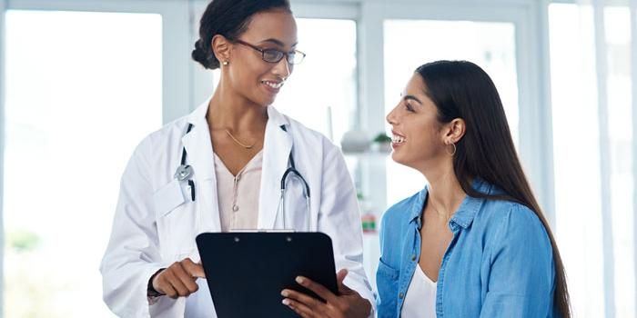 doctor smiling at female patient