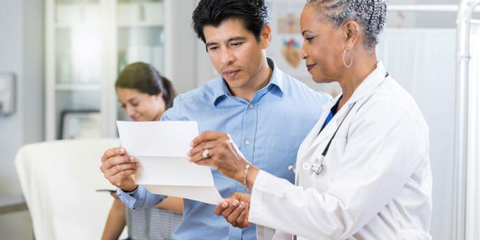 man holding paper next to doctor