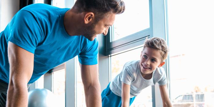 man and boy doing push-ups