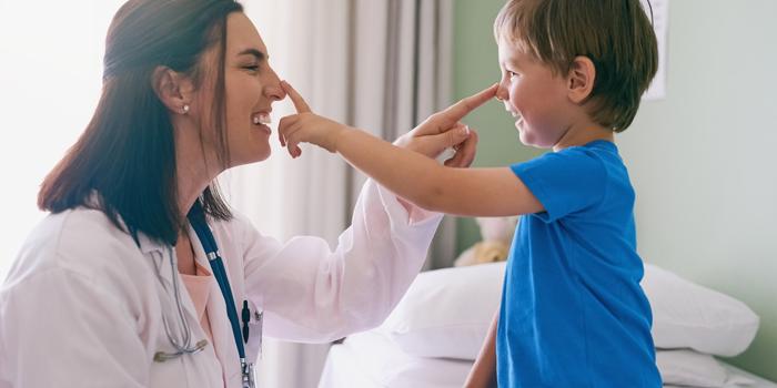 doctor touching boys nose