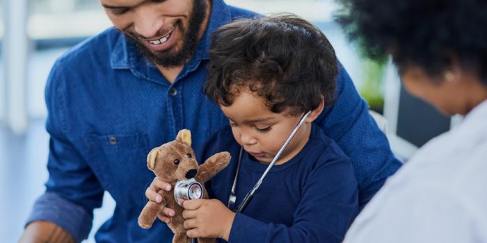 boy holding a teddy bear in hospital