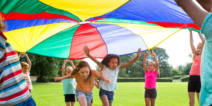 kids running under umbrella
