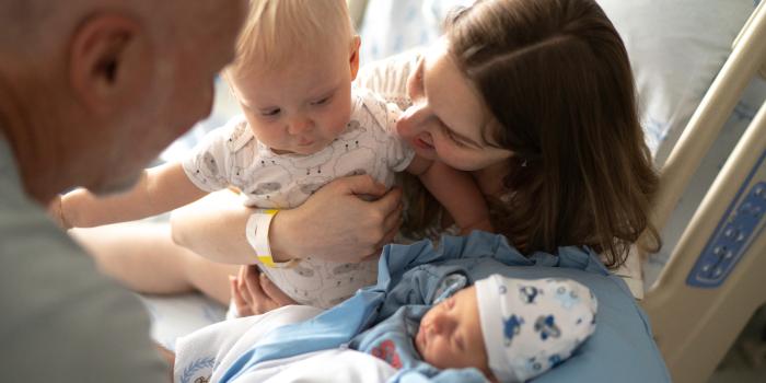 family snuggling with baby