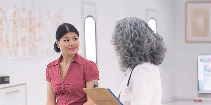 Breast cancer patient speaking with her doctor