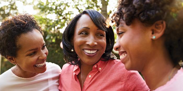 Three women laughing and enjoying the moment together at HMG Exeter OBGYN 