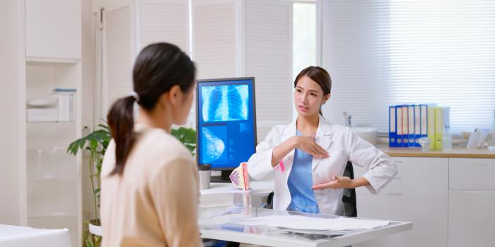 A physician and her patient discussing a referral to the Breast Health Center.