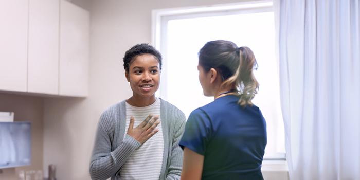 A woman discussing breast surgery with her healthcare provider.