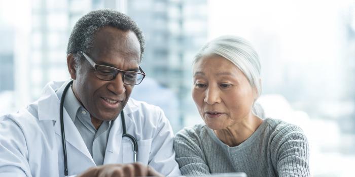Female patient viewing information with doctor
