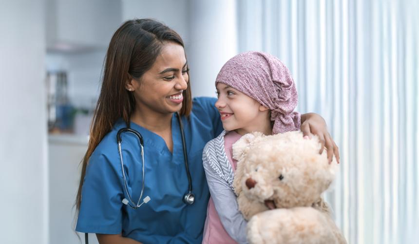Young cancer patient smiling with medical provider 