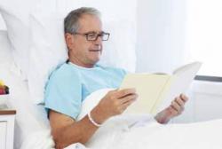 Man reading in hospital bed